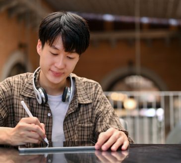 Young man working on digital tablet