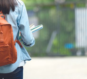 Back of student wearing backpack
