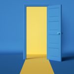 Yellow light emerging from open blue door