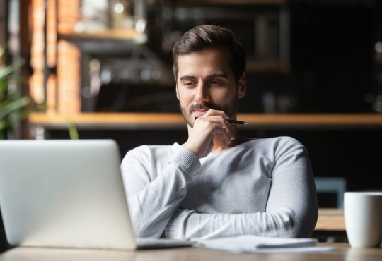 Man watching webinar on laptop