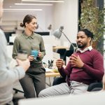 Group of coworkers having coffee in office