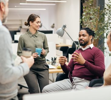 Group of coworkers having coffee in office