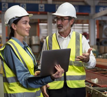 Engineers talking in manufacturing facility