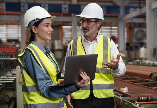 Engineers talking in manufacturing facility
