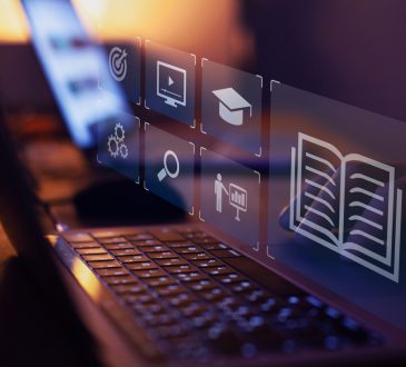 e-learning – image of laptop with icons representing learning floating above