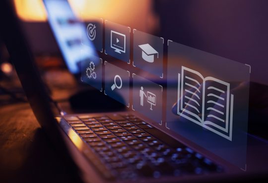 e-learning – image of laptop with icons representing learning floating above