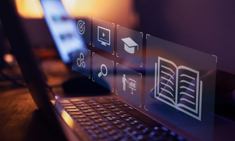 e-learning – image of laptop with icons representing learning floating above