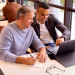Two people working together at table
