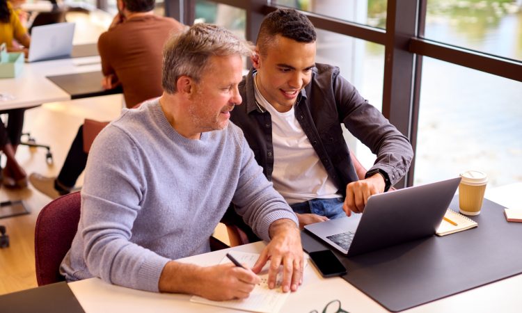 Two people working together at table
