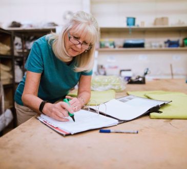 Woman doing paperwork in workshop