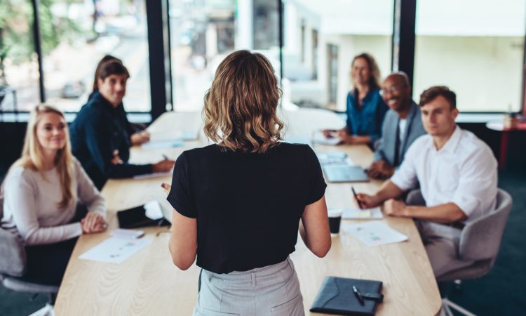 Woman delivering presentation in boardroom.