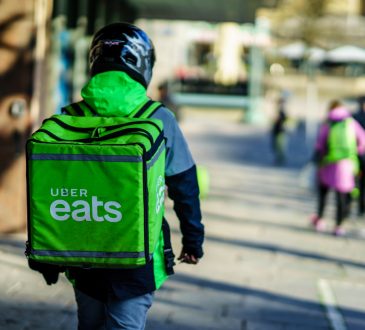 Uber Eats delivery person walking with bag on back