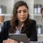 Two women talking in office