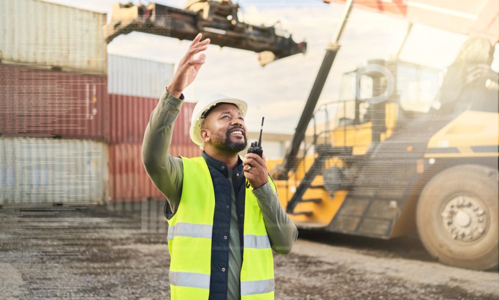 Man speaking into radio on construction site