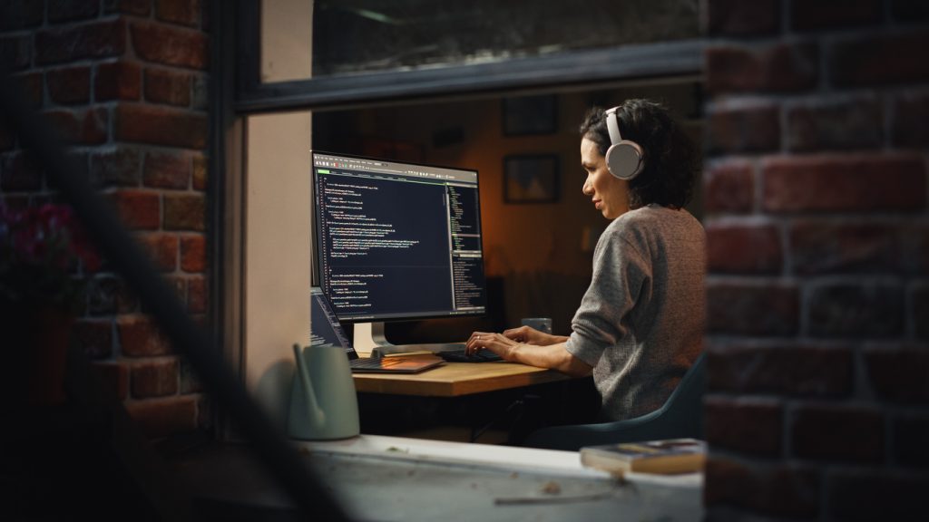 Woman working on computer at home in evening
