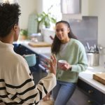Mother Talking With Teenage Daughter At Home In Kitchen