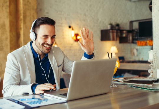 Man have business meeting via video call in home office
