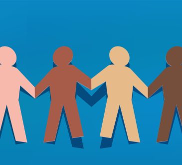 Paper chain of human cutouts of different skin tones holding hands.