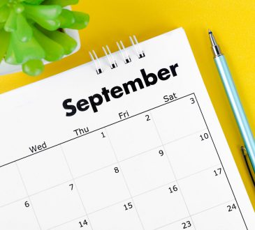 Corner of a desk calendar with September written on it.
