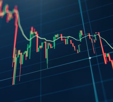 Crypto diagram with green and red candlesticks on blue display.