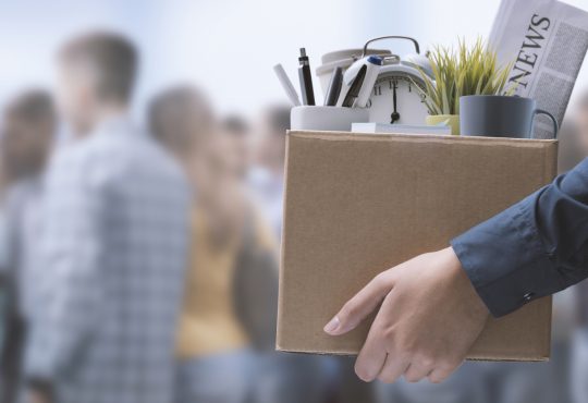 Person carrying box filled with office items
