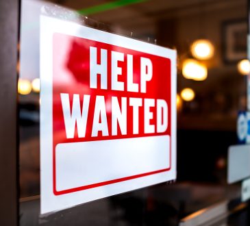 help wanted sign in a window.