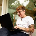 Person working with laptop on lap