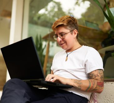 Person working with laptop on lap