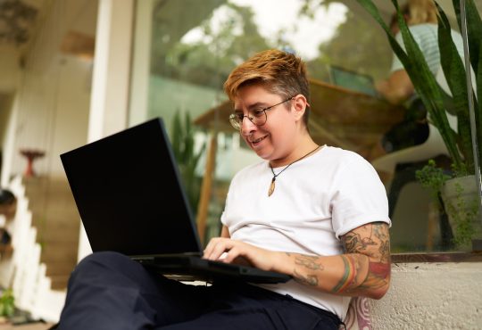 Person working with laptop on lap