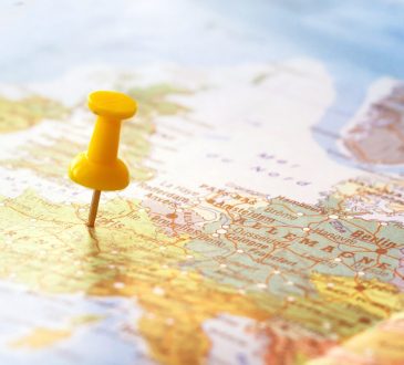 Yellow pin sticking into world map