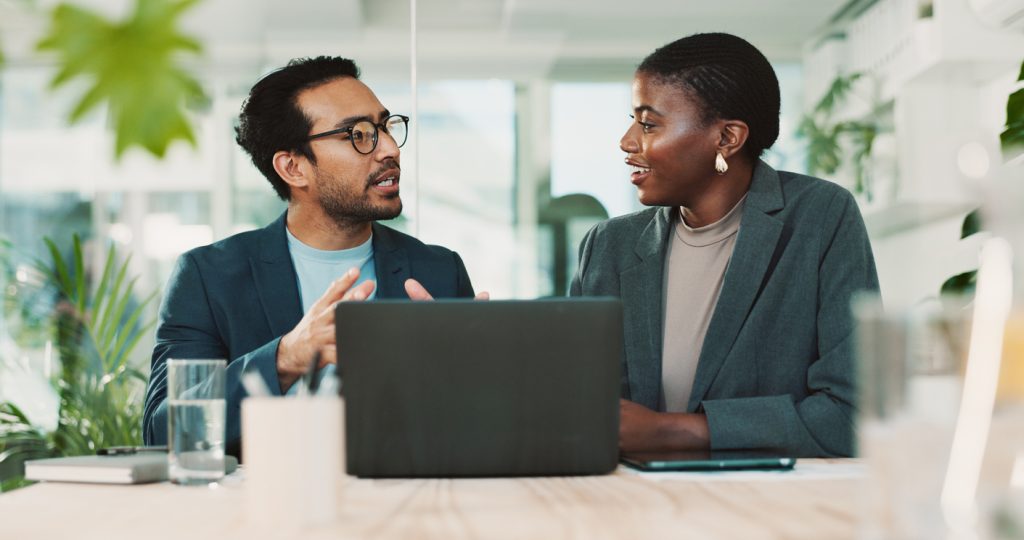 Man and woman talking in office