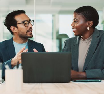 Man and woman talking in office
