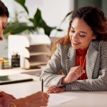 Two people looking at document in office