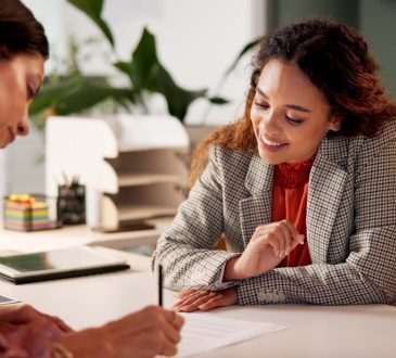 Two people looking at document in office