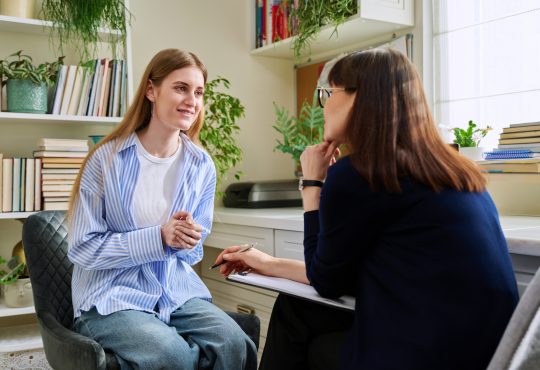 Teen talking to school counsellor in office