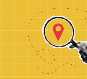 Photo illustration of hand holding magnifying glass on top of map