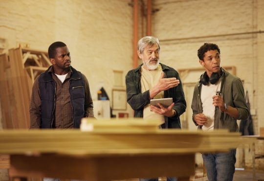 Workshop, men and group with tablet, carpenter or discussion with research, woodworking or technique. People, mature mentor and review of info