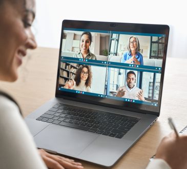 African American female student having video call videoconference on laptop. stock photo