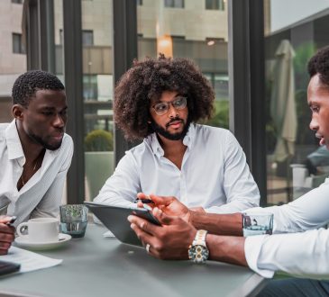 Multiracial business people working outdoor using digital tablet
