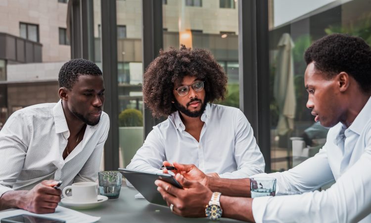 Multiracial business people working outdoor using digital tablet